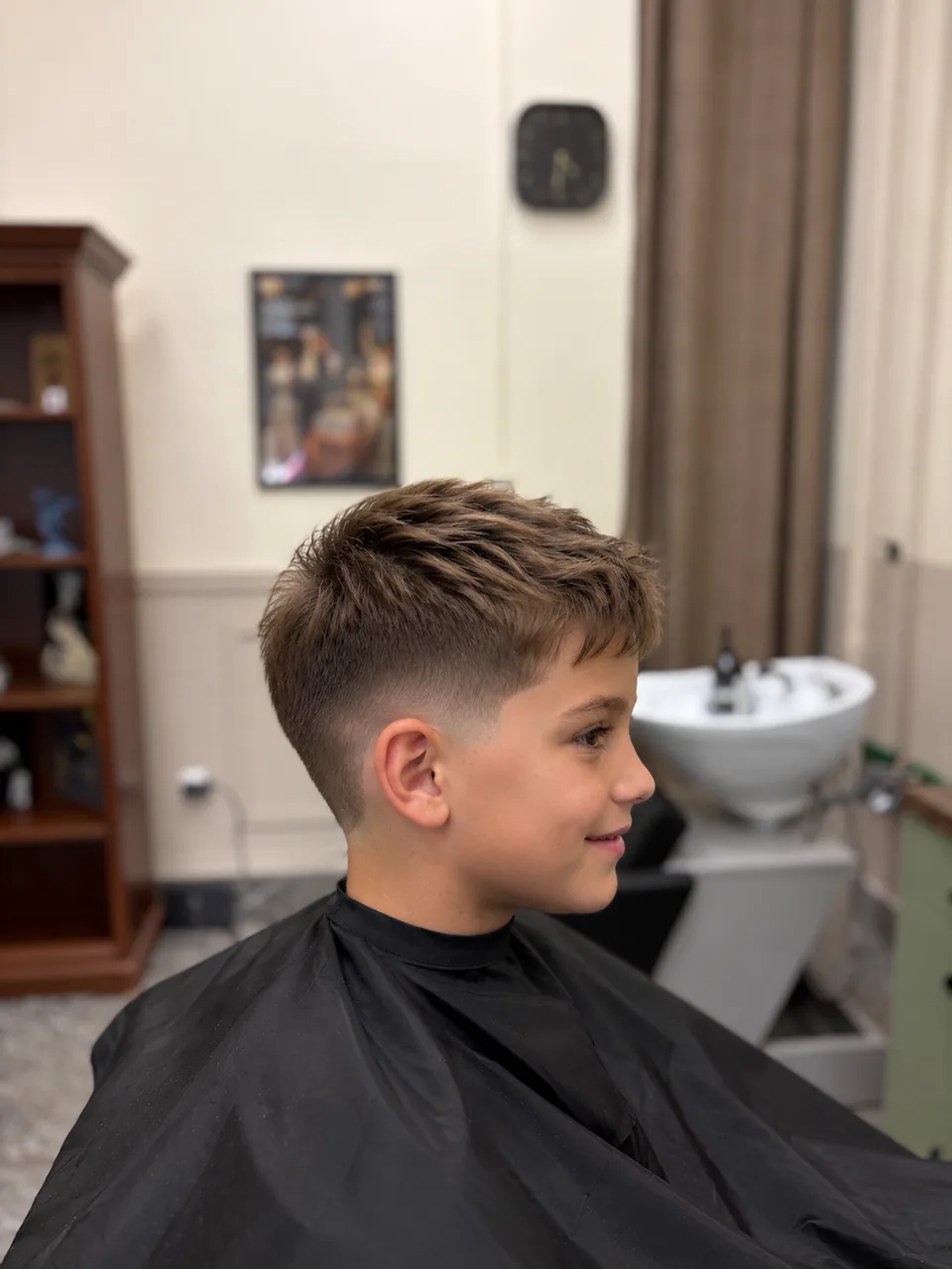 Illustrative photo: Boy with a short haircut in a barber’s chair